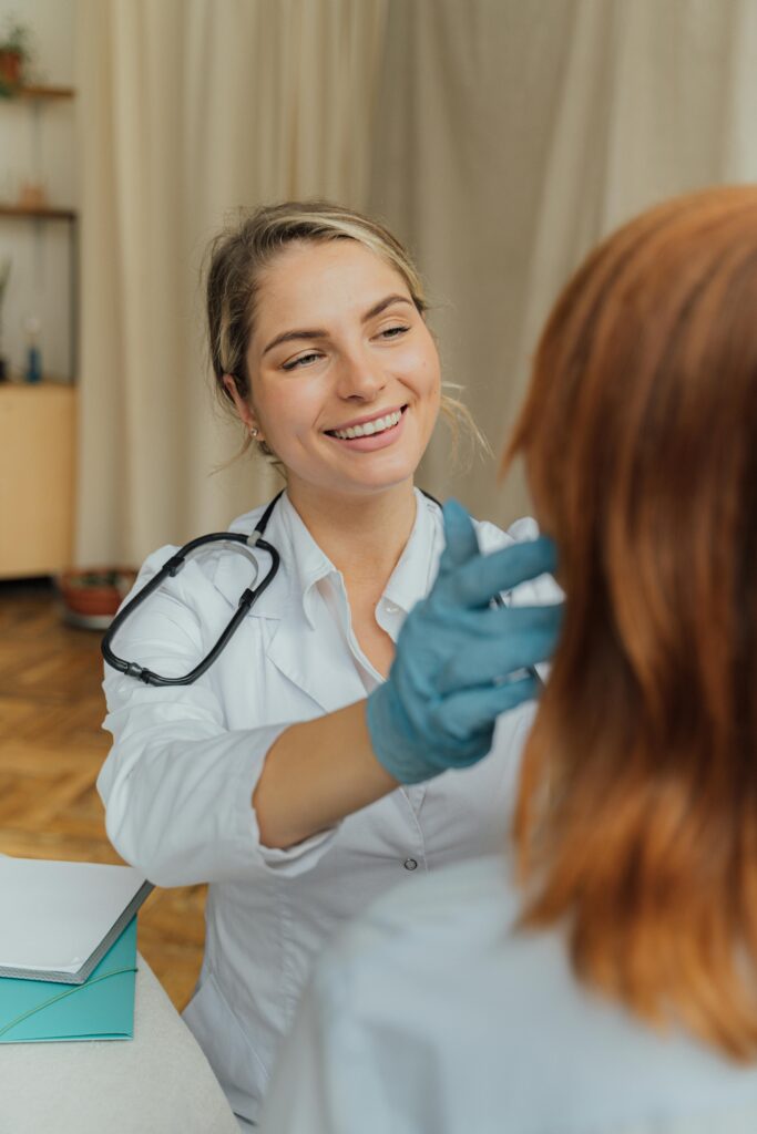 pexels-photo-5215017-5215017 A cheerful healthcare professional examining a patient indoors, promoting positive healthcare experiences.